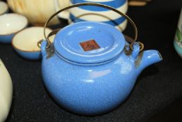 A crackle glaze tea pot along with three tea bowls.