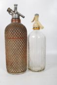 2 glass soda siphons, one marked Schweppes to front. 35cm tall.