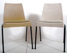 A pair of 1970's plastic workmans retro chairs having tubular metal frames with good shaped frames
