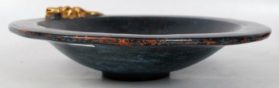 A 1930's Art Deco bowl being black and blue bearing golden lizard gecko to the edge.