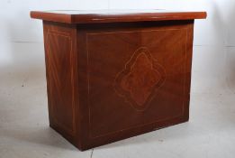 A mahogany inlaid reception desk having glass inset top with a series of drawers to the rear and