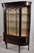 An Edwardian solid mahogany bow front display cabinet. Square tapered legs with astragal glazed
