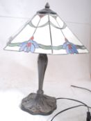 A good quality tiffany table lamp having milk glass and coloured shade with pewter style lamp on