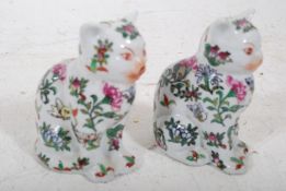 2 20th century Chinese famille rose foliate decorarted cat figurines. All over floral patterns to
