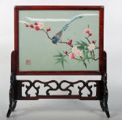 A Chinese rosewood table top dreamstone screen. The fret carved screen of rosewood construction