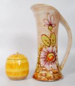 A Royal Art Pottery decorative shaped ewer / vase / jug having ribbed design together with a Shelley