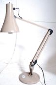A retro beige anglepoise lamp having circular terraced base with sprung arm and good shape shade