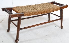 A decorative early 20th century rattan weave footstool. Carry handles to sides with angular legs