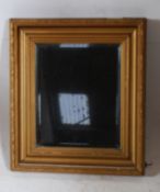 A 19th century Victorian gilt framed bevelled edge wall mirror of square form with deep frame. 57cms