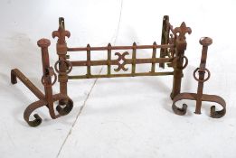 A cast iron Victorian fire grate in the medieval style complete with the matching fire dogs /