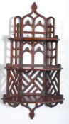 A mid 20th century mahogany fret carved corner shelf having 3 tiers with a decorative fret carved