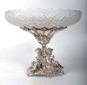 A silver plated and etched glass fruit bowl, on stand, with cherub decoration to base. 19cm x 23cm