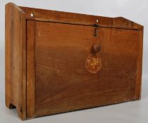 A mid 20th century wooden retro vintage first aid box with fall front housing shelved interior