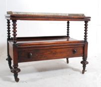 A Victorian rosewood and burr walnut canterbury stand. The turned legs with castors supporting a