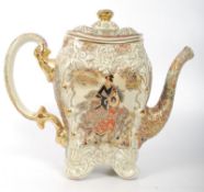 An early 20th century Japanese Satsuma ware teapot having raised decorative design with central