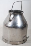 A belgian polished metal milk churn having carry handle atop and to side. 36cms High