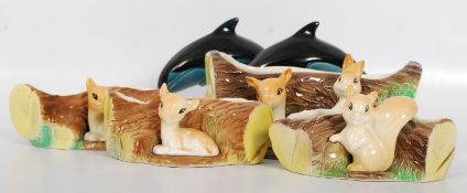 Two Poole pottery dolphins together with four pieces of Hornsea pottery.