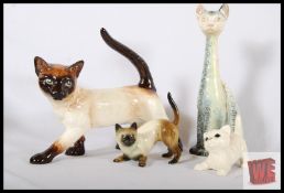 A quantity of 4 porcelain cats, to include one SylvaC, one Goebel and two others. The largest