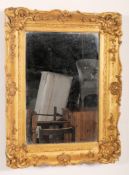 A Victorian gilt wood wall mirror with gold leaf scrolled frame. Gilt pine construction with