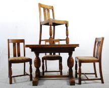 1930's solid oak draw leaf dining table together with the 4 matching dining chairs. 76cms high x