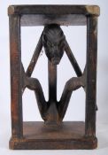 An african hardwood tribal art carved stand / table. The seated figure supporting oak tiers above
