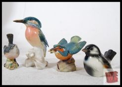 A collection of 4 bird figurines. A Royal Worcester Kingfisher (Reg 3235, 8cm tall), a Beswick