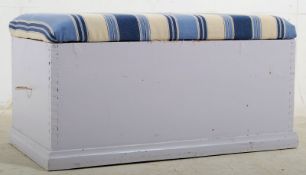 A 19th century shabby chic painted pine blanket box ottoman. Plinth base with panelled sides