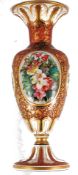 A 19th century Bohemian cranberry glass vase handpainted with decorative scene, being gilt
