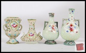 Four early 20th century miniature Viennese vases, the tallest being 13cm tall.