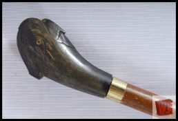 A vintage walking stick with carved parrot head handle