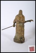 A bronze Chinese figure of Guan Yu coloured in gilt relief. 23cm high.