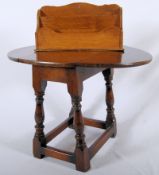 A 1920's 17th century style solid oak butterfly / coffin occasional table. Together with an oak desk