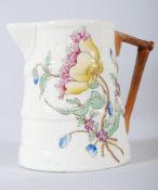 A Royal Worcester stick handled small jug decorated with flowers bearing backstamp dating to 1952.