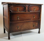 1930's Jacobean revival oak chest of drawers. The squared legs with castors supporting a low chest