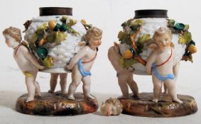 A pair of 19th century Meissen cherub porcelain vases, each having cherub supports encrusted with