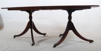A Georgian style mahogany twin pedestal dining table. Reeded legs with paw feet and 2 detachable