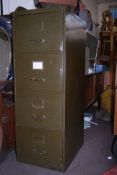 A 1930's green ex military metal 4 drawer filing cabinet. The drawers with brass hoop handles and
