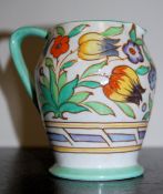 A Charlotte Rhead Bursley Ware tulip floral pattern jug. The cream background painted with tube
