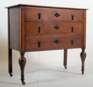 1930's Jacobean revival oak chest of drawers. The cup and cover legs with castors supporting a low