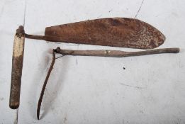 A Victorian 19th century vintage farm scythe with another vintage farm tool