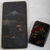 Two vintage chinoserie cigarette cases one Amita the other 'Made In Japan.' The Amita depicting