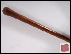 A vintage heavy walking cane with inset compass to top