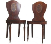 A pair of Georgian / George IV, circa 1830 mahogany armorial hall chairs. Shield shaped back rests