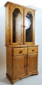 A Ducal pine library bookcase display cabinet cupboard. The cabinet appearing to be a wall fixed