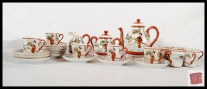 A Japanese translucent hand painted tea set for 12 to include teapot, sugar bowl and milk jug