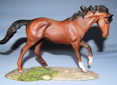 A Royal Doulton model of a horse, 'The Winner' on a wooden plinth from the Connoisseur Horse series.