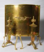 A pair of brass fire dogs and matching fire screen