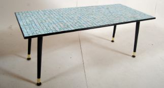 A 1970's retro mosaic coffee table of rectangular form in many colours finished with black