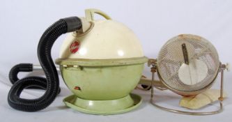 A 1950's retro atomic Winfield heater having tubular base with red and white mesh body above.