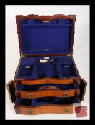 An Edwardian serpentine mahogany cutlery canteen by Walker & Hall. The hinged top having 2 drawers